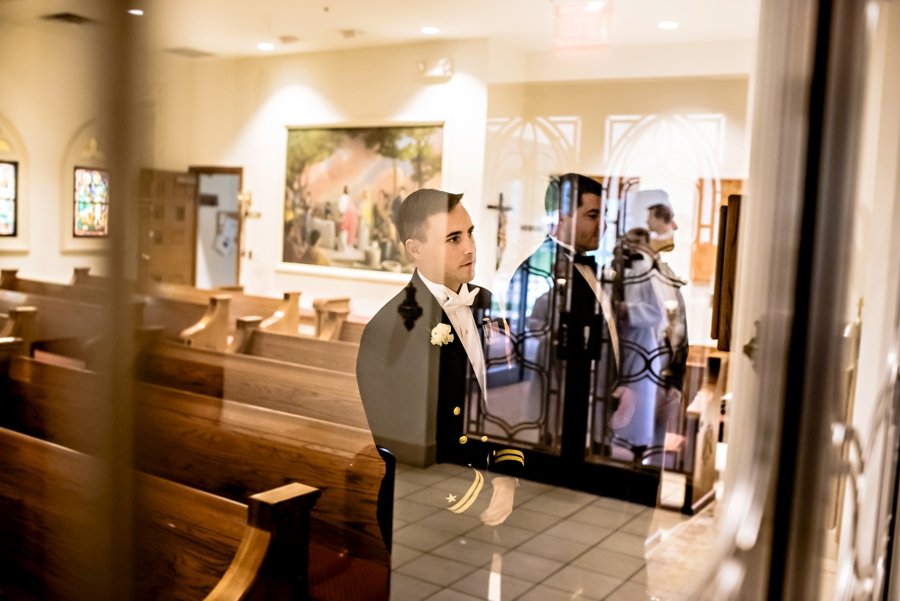 The groom waits in the back of the church before the ceremony.